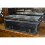 A 19TH CENTURY BRASS AND HIDE TRUNK, with studded brass and banded detail, double drop down