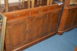 A YEW WOOD SIDEBOARD, with three drawers and a large matching open corner cabinet (six keys) (2)