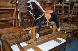 A FABRIC ROCKING HORSE, on an oak frame, approximate size length 137cm x height 117cm