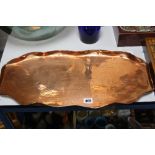 AN ARTS & CRAFTS STYLE OVAL COPPER TRAY, wavy edge surrounding a stamped design of two fish,