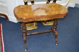 A VICTORIAN BURR WALNUT AND INLAID FOLD OVER CARD TABLE, serpentine fold over top, on carved