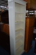 A TALL PAINTED PINE OPEN BOOKCASE