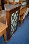 AN OAK ASTRAGAL GLAZED HANGING CORNER CUPBOARD, with painted interior