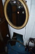 A CARVED CIRCULAR ANEROID BAROMETER, oval bevelled wall mirror and two other wall mirrors (4)