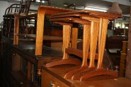 A TEAK COFFEE TABLE, with glass insert, a nest of three tables, a corner unit, a hi-fi cabinet and a