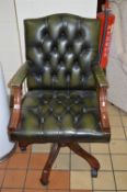A GREEN LEATHER BUTTONED SWIVEL STUDY ARMCHAIR (sd)