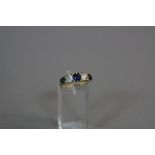 A SAPPHIRE AND DIAMOND RING, with three graduated round cut sapphires and two old round cut