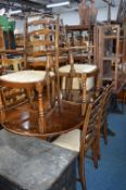 AN OAK EXTENDING DINING TABLE, and six chairs including two carvers (sd) (7)