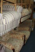 A FLORAL UPHOLSTERED THREE PIECE SUITE, comprising of a two seater settee and a pair of armchairs