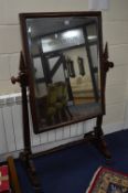 A VICTORIAN MAHOGANY CHEVAL MIRROR, on turned supports below spiral shaped finials, approximate size