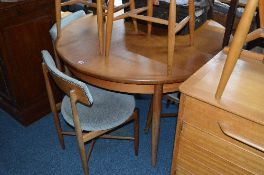 A TEAK G PLAN FRESCO CIRCULAR EXTENDING DINING TABLE, and four matching chairs (5)