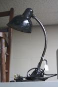 A BLACK PAINTED VINTAGE DESK LAMP, with adjustable shade and support cast base (please note item