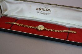 A 9CT LADIES ENICAR WRISTWATCH, on a 9ct expandable strap (boxed), approximate weight 11.4 grams