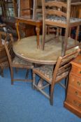 AN OAK CIRCULAR TRIPOD DINING TABLE, and six chairs including two carvers