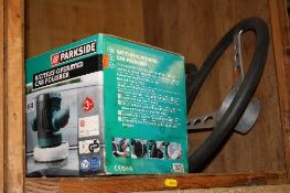 A BOXED ELECTRIC CAR POLISHER, and two racing steering wheels (3)