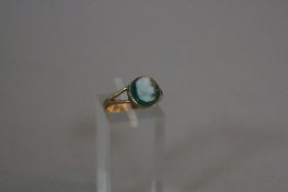 A 9CT GOLD AND GREEN CAMEO RING, ring size N, approximate weight 2.0 grams