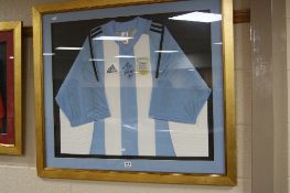 A FRAMED SIGNED ARGENTINA SHIRT, 2003/2004, ( with a certificate, possibly Maradonna)