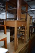 A PINE SCHOOL DESK, a mahogany nest of three tables, a wine rack, jardiniere stand, sewing box,
