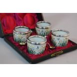 A LATE 19TH CENTURY CASED SET OF FOUR FRENCH OPAQUE GLASS CIRCULAR SALTS, enamelled with flowers and