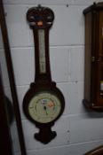 A CARVED OAK ANEROID BAROMETER, W A Perry & Co, Birmingham