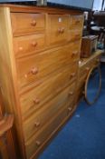 A LARGE SATINWOOD CHEST, of nine various drawers and a matching dressing table with oval mirror (2)