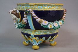 A JOSEPH HOLDCROFT MAJOLICA JARDINIERE, turquoise glazed interior and exterior with female mask