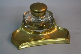 A VICTORIAN BRASS DESKSTAND, fitted with an oval glass inkwell of large proportions, circular