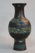 A LATE 19TH/EARLY 20TH CENTURY ORIENTAL CHAMPLEVE ENAMEL AND BRONZE VASE, bears marks to the