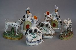 TWO VICTORIAN STAFFORDSHIRE POTTERY SPILL VASES, in the form of a dog rescuing a child from a