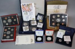 A SMALL COLLECTION OF SILVER PROOF YEAR SETS, etc, to include boxed silver proof five pounds 1997,