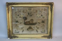 A WILLIAM IV NEEDLEWORK PICTURE, of a central recumbant Lion surrounded by flowers and foliage,