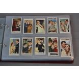 A CIGARETTE CARD ALBUM, containing loosely inserted cards all featuring Film Stars, mixture of