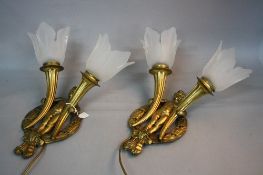 A PAIR OF 20TH CENTURY ORMOLU WALL LIGHTS, each cast as a naked boy within a circle of leaves