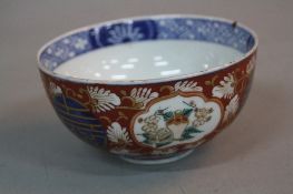 A LATE 19TH CENTURY JAPANESE IMARI BOWL, the exterior painted with panels of vases and foliage,