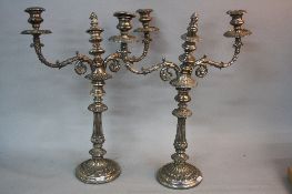 A PAIR OF 19TH CENTURY SILVER PLATED CANDELABRA, three branch, foliate cast drip pans, sconces and