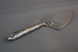 A VICTORIAN SILVER TROWEL, the blade engraved with a border of discs surrounding foliate scrolls,