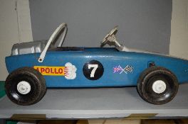 A VINTAGE PRESSED STEEL PEDAL CAR, in the form of a Formula 1 Racing Car, c. Late 1960's or early