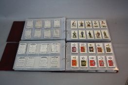 TWO CIGARETTE CARD ALBUMS, containing loosely inserted cards mainly on military, nautical and