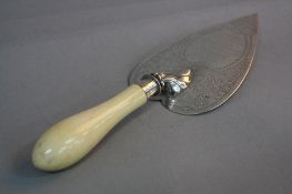 A LATE VICTORIAN SILVER TROWEL, the heart shaped blade engraved with foliate decoration