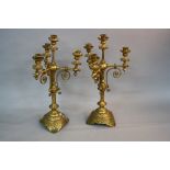 A PAIR OF VICTORIAN GOTHIC GILT METAL CANDELABRA, four branch with circular drip pans on turned arms