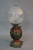 A LATE VICTORIAN MESSENGERS NO.2 BRASS AND CERAMIC OIL LAMP, the spherical globe above reservoir and