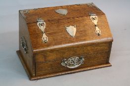 A LATE VICTORIAN OAK SMOKER'S BOX, with silver plated mounts, sloped front opening to reveal a