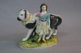 A LATE VICTORIAN STAFFORDSHIRE POTTERY FIGURE OF A GIRL STANDING IN FRONT OF A LARGE DOG, on an oval