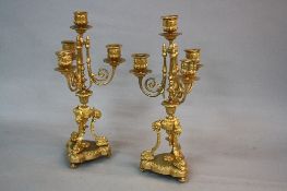 A PAIR OF MID 19TH CENTURY ORMOLU FOUR BRANCH CANDELABRA GARNITURES, beaded rims to sconces and drip