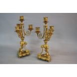 A PAIR OF MID 19TH CENTURY ORMOLU FOUR BRANCH CANDELABRA GARNITURES, beaded rims to sconces and drip