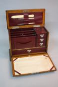 AN EDWARDIAN OAK STATIONERY BOX, the fall front fitted with blotter paper, the interior with
