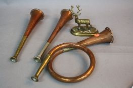THREE COPPER HUNTING HORNS, one is a single coil horn with brass mouthpiece, length approximately