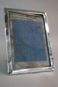 A GEORGE V RECTANGULAR SILVER PHOTOGRAPH FRAME, easel back, inner dimensions approximately 27cm x