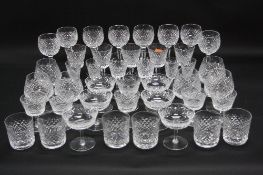 A SUITE OF WATERFORD CRYSTAL DRINKING GLASSES, hobnail cut, comprising six whisky tumblers, four