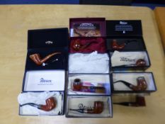A COLLECTION OF PETERSON OF DUBLIN PIPES AND WOODEN DISPLAY STANDS, including several pipe of the